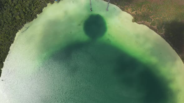 Aerial Birds Eye Overhead Top Down Panning View of Beautiful Green Lake Used As Natural Swimming