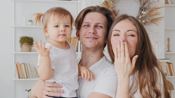 Happy Caucasian Family Young Millennial Parents Mother and Father with Little Daughter Infant