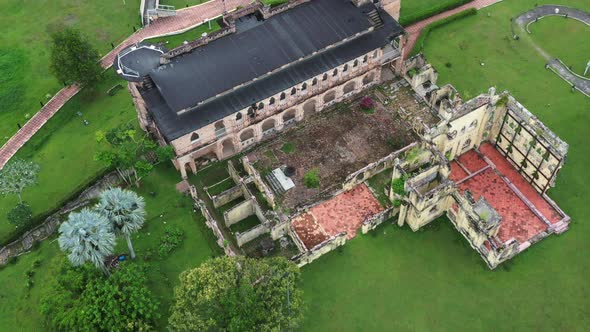 Birds eye view tilt up reveals the historic riverside Kellie's castle, capturing the backyard and un