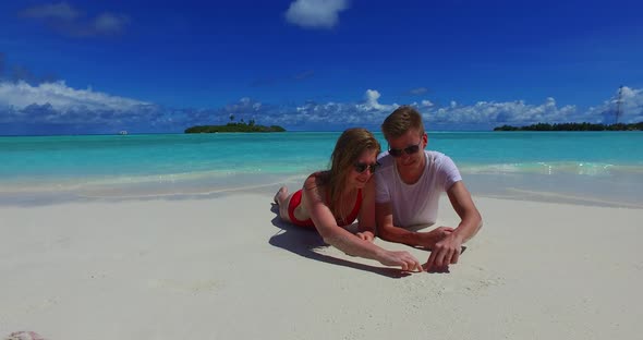 Romantic couple married on vacation enjoy life on beach on white sand background 