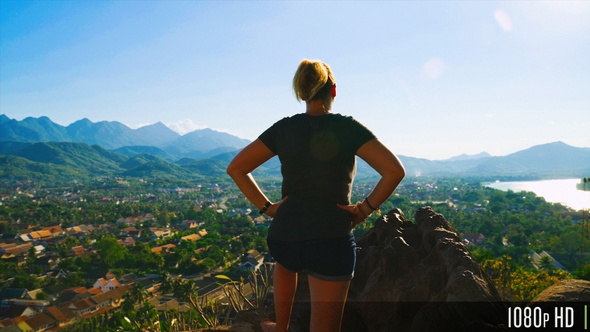 Rear View of Carefree Woman Taking in Scenic Top View of City and Mountains