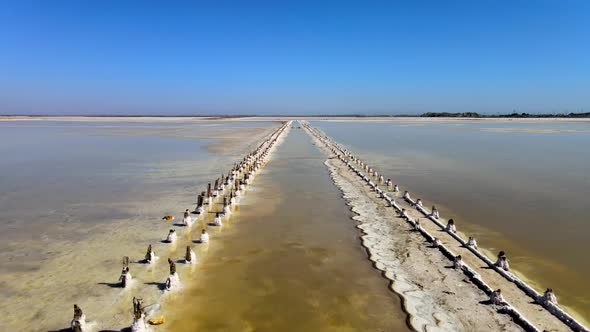 Abandoned Pier on Multicolored Lake Medicinal Clay Ungraded on Sunset, Air Drone View