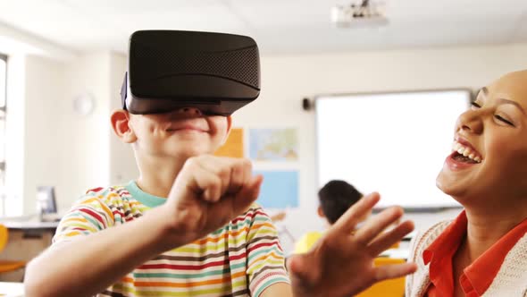 Boy using virtual reality headset in classroom