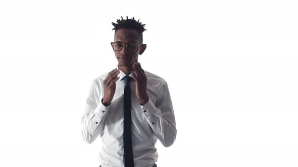 Black Office Man in a Suit Rubs Eyes and Takes Off Glasses on a White Background