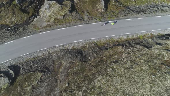 Cyclists in Helmets Are Racing on Mountain Road in Norway. Aerial Vertical Top-Down View