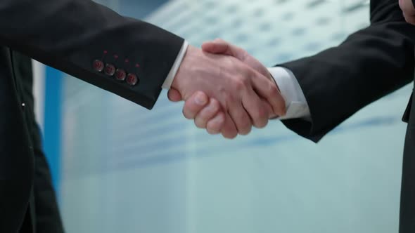 Handshake of Two Businessmen in Office Indoors