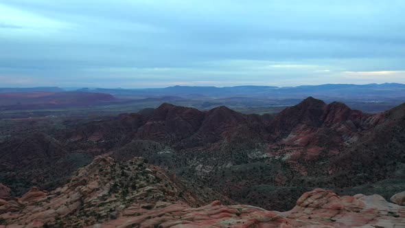 Distant view of the top of the desert mountains with a view of the valley and the horizon of the blu