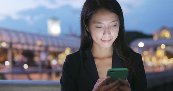 Business woman use of smart phone at night 