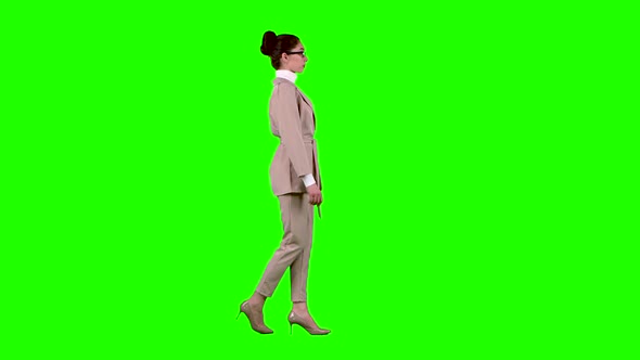 Business Lady Is Going To a Meeting. Green Screen. Side View