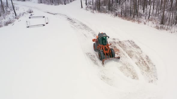 Piling up snow with a front end loader