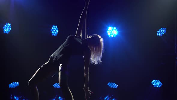 Pretty Sexy Woman Doing Poledance in Smoky Studio