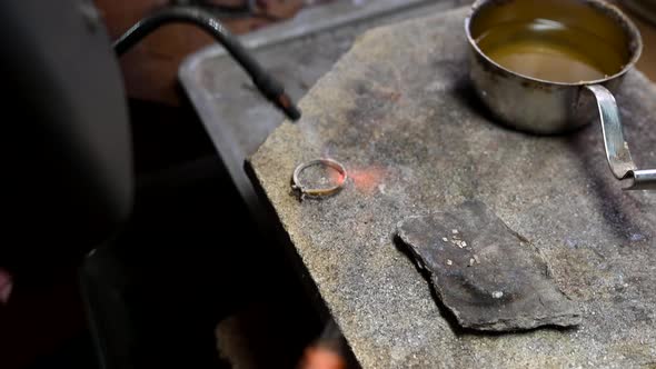 Closeup of Wedding Ring Crafting By Caicasian Jeweler in Home Workroom  High Quality Footage