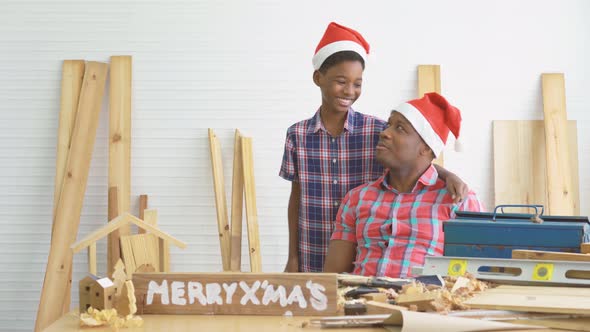 Cheerful african american son carpenter dancing moves to happy with father happily 