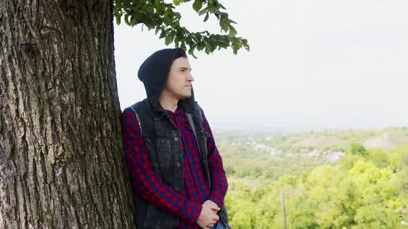 Young Man Standing Near Tree in Nature