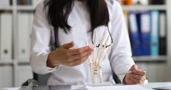 Doctor Traumatologist Surgeon Shows Sample of Skeleton of Hands