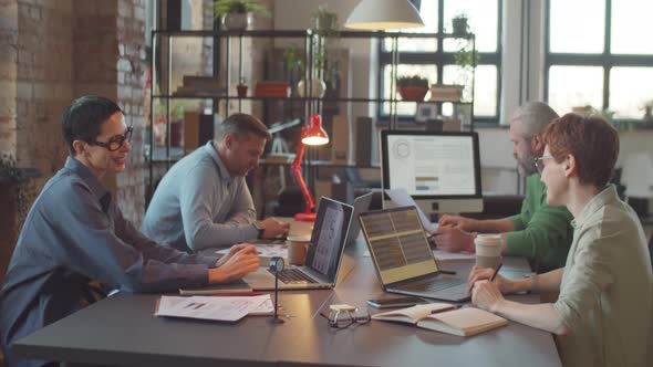 Female Colleagues Discussing Business at Coworking Office Table