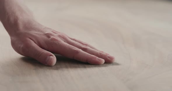 Slow Motion Slide Orbit Shot of Man Hand Checking Sanded Black Walnut Wood Table