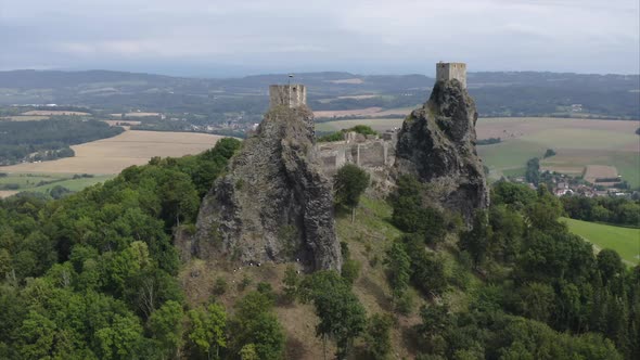 Two towers of the Trosky castle ruins above a vast Czech countryside.