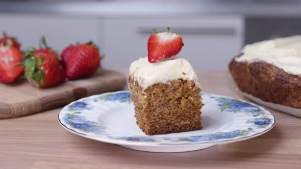 Portion Of Baked Carrot Cake With Fresh Sliced Strawberry On The Top - close up