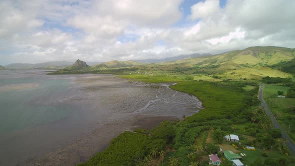 Fiji Travel - Mid Tide Aerial Drone Flight Panorama of mountains near the ocean.