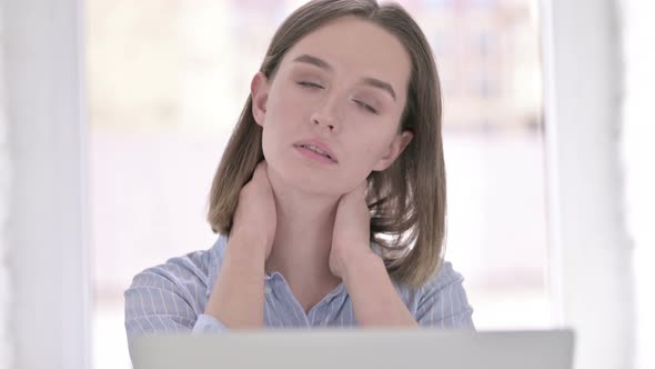 Portrait of Hardworking Young Woman Having Neck Pain in Office