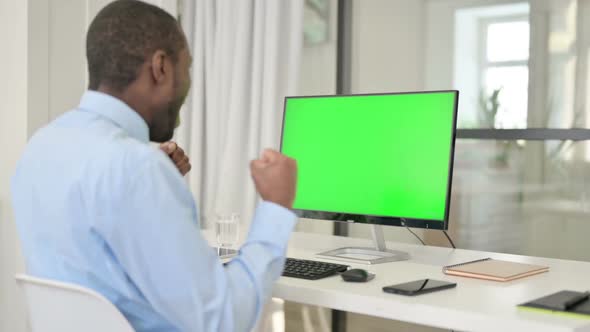 Businessman Celebrating While Using Desktop with Green Chroma Key Screen