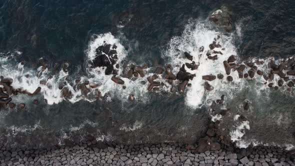 Stone Beach and Waves Crashing Over Big Volcanic Rocks