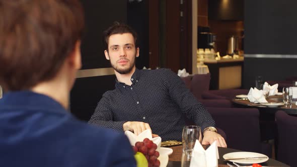 Active Man and Woman Having Business Dinner at Restaurant