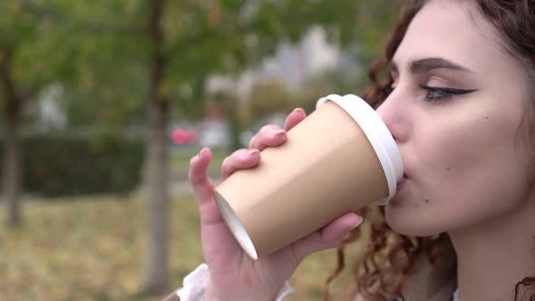 Young Attractive Woman Drinking Coffee Outdoors