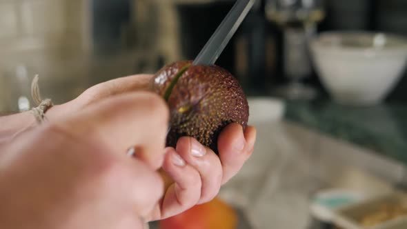 Chef Man Showing Hands Fresh Avocado in Close Up in Restaurant Kitchen Cafe