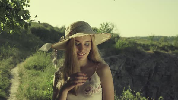 Girl in Hat on Nature Background