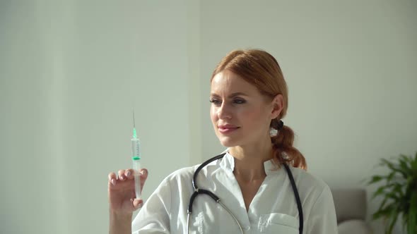 Caucasian Female Doctor Preparing Syringe for Injection in Modern Clinic