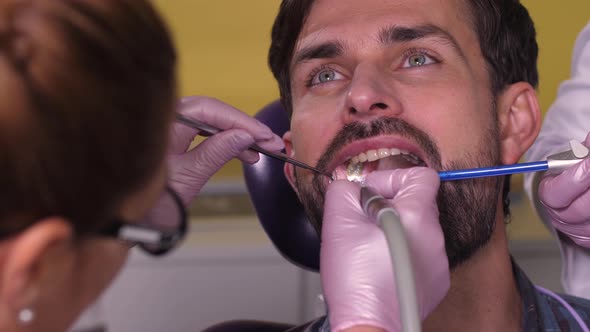 Portrait of Male During Process of Tooth Drilling