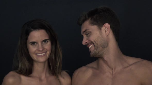 Couple with bare shoulders smiling cheerfully