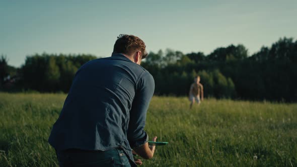 Man playing with son the toy airplane at meadow. Shot with RED helium camera in 4K.