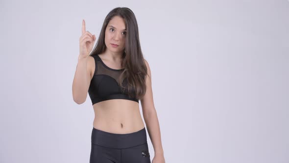 Young Beautiful Multi-ethnic Woman Pointing Up Ready for Gym
