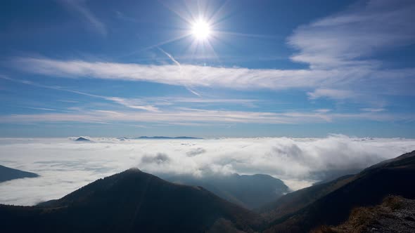 Clouds over the landscape, Sun at noon in motion inversion low clouds,