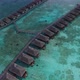 Aerial view of over water villas on Maldivian island with turquoise crystal clear water - VideoHive Item for Sale