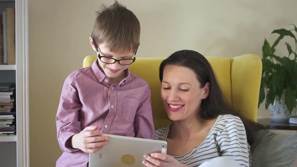 Mother and Son are Using Tablet and Having Happy Time Together at Home During Quarantine Spbd