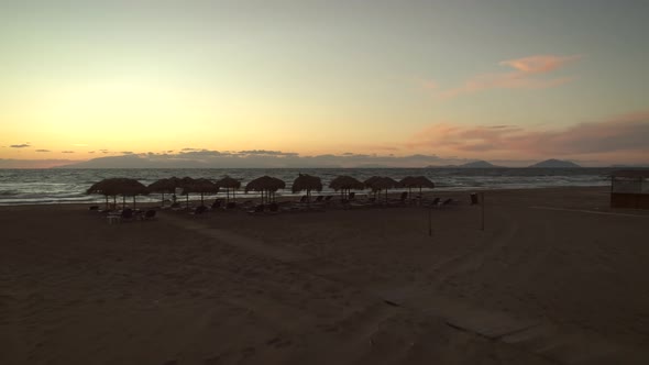 Aerial view of a empty sandy beach at sunset in Greece.