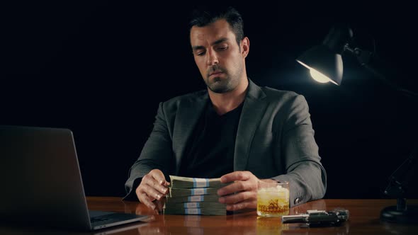 Handsome man plays with a stack of cash