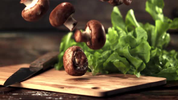 Super Slow Motion Mushrooms Fall on the Cutting Board