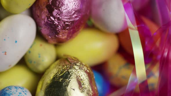 Rotating shot of colorful Easter candies on a bed of easter grass