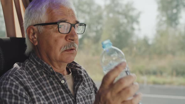 Nervous Senior Man Taking Pills before Bus Ride