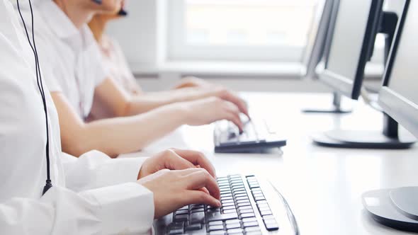 Diverse team of young professionals is working in the phone support office.