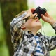 Young Boy Looking Through Binoculars In Wood - VideoHive Item for Sale