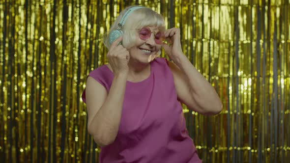 Senior Old Woman Dances, Listens Music on Headphones. Relaxing, Enjoying, Having Fun, Smiling