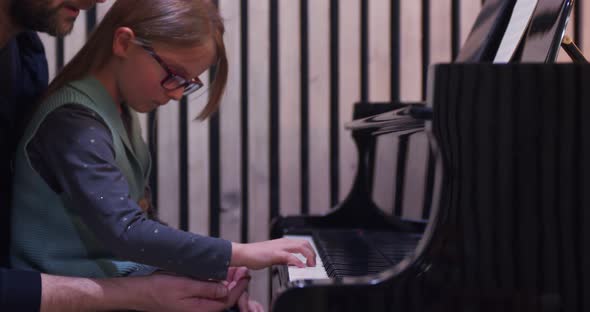 Dad Teaching Piano to His Daughter