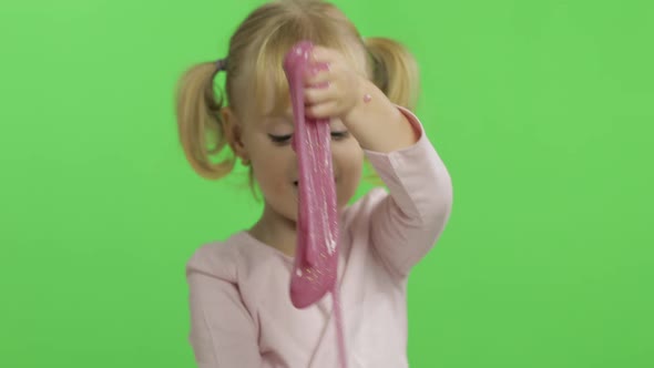 Kid Playing with Hand Made Toy Slime. Child Having Fun Making Pink Slime