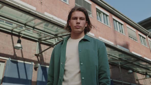 Portrait of Young Man in Casual Clothes Standing on Street